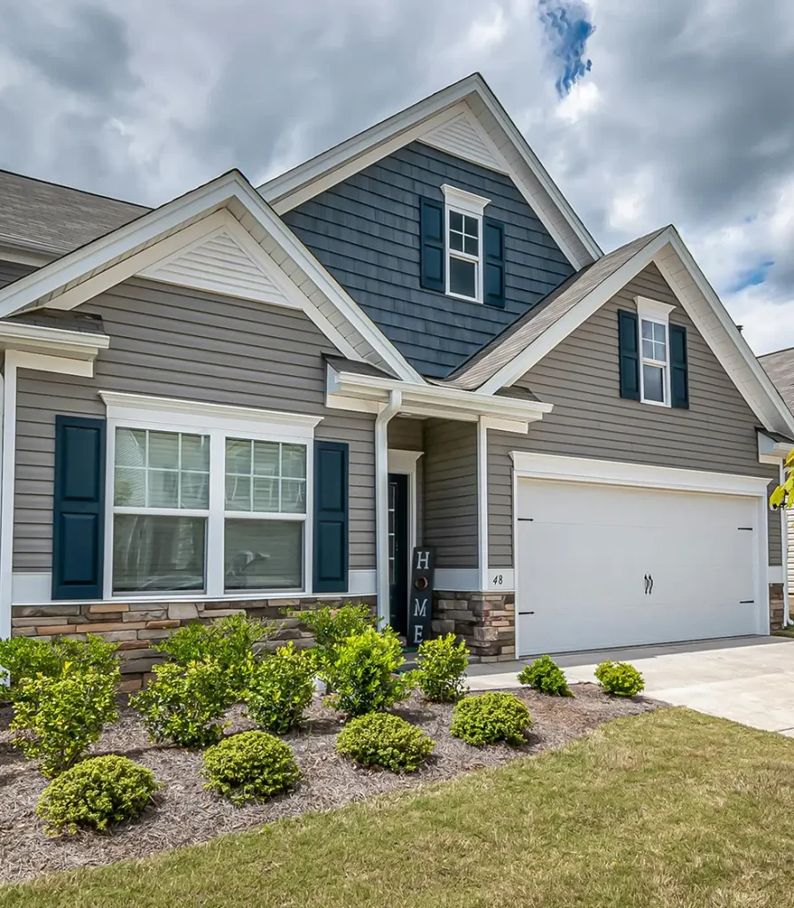 Modern suburban gray house with landscaped front yard