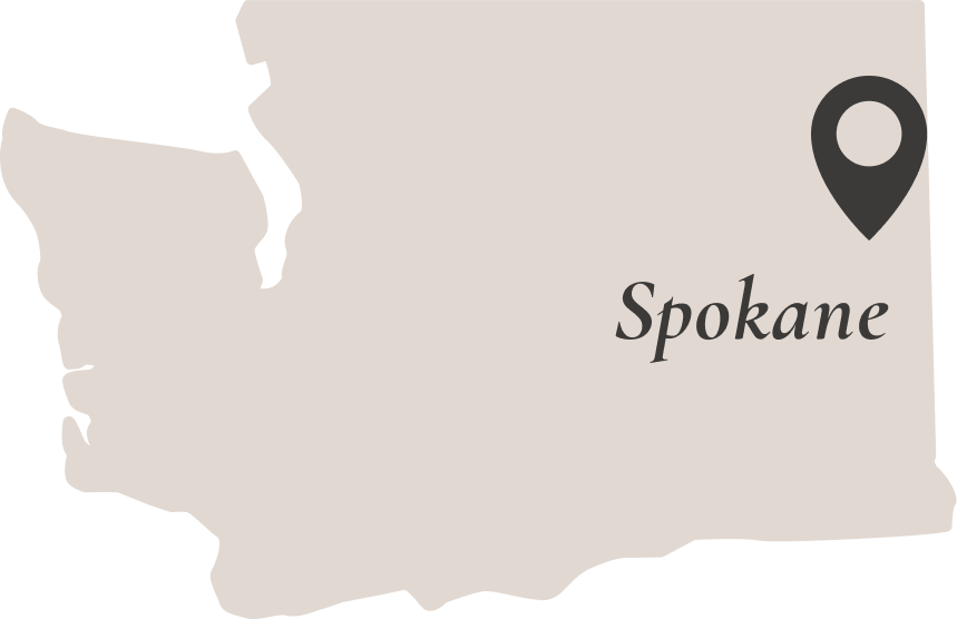 Outline of Washington State with a pin for Spokane in the north east corner of the state.
